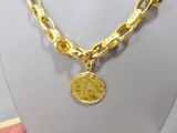 necklace with a coin on a gold chain on a mannequin