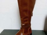 the brown boots are sitting on top of a black box