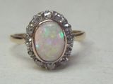 an oplite and diamond ring is shown on a white surface