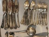 a lot of silver spoons and spoon spoons on the table