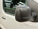 an image of a side view mirror of a white van