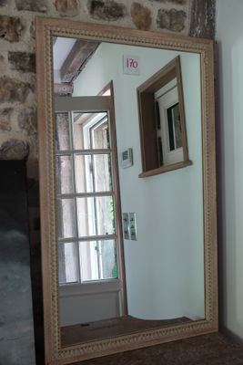 a mirror in the corner of a room next to a door