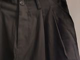 a close up of a black skirt hanging on a hanger