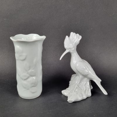two white vases sitting next to each other on a table
