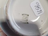 a person holding a white cup with a sticker on it