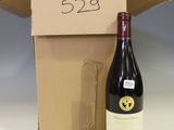 a bottle of wine sitting next to a cardboard box