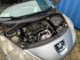 a small car with its hood open and the engine in the trunk