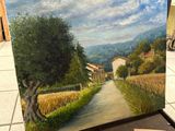 a picture of a painting of a country road on a table