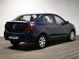 a picture of a small blue car parked in a garage