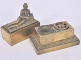 pair of antique brass figurines of a woman sitting on a box