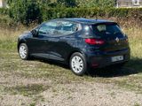 a black car that is parked in the grass