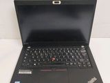 a black laptop computer sitting on a white table