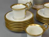 a lot of cups and saucers that are sitting on the table
