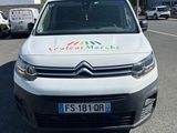 a white van parked in a parking lot next to a building