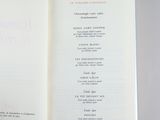 an open book on a table with a bunch of writing on it