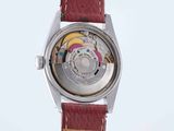 an image of a close up of a wrist watch with a red strap
