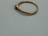 a gold ring with a skull on it sitting on a table