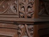 a wooden cabinet with carvings on the top of it