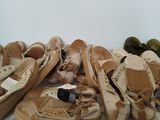 many pairs of shoes that are on a shelf