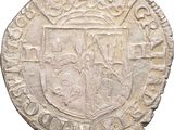 a close up of a coin with a coat of arms on it