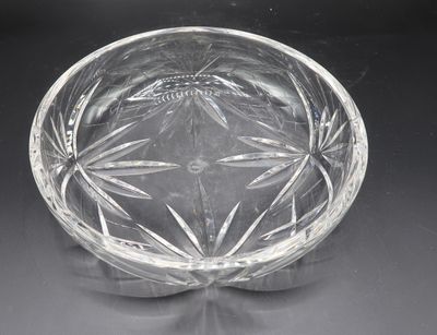 a clear glass bowl with a flower design on it