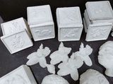 a lot of white ceramic figurines sitting on a table