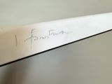 a close up of a knife with a writing on it