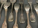 a lot of silver spoons and forks on the table