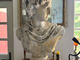 a bust of a woman sitting on a table in a room
