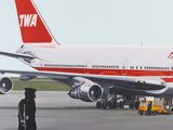 a painting of an airplane on a runway with a man standing in front of it