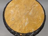 a round table with a marble top on a metal stand