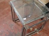 a glass table with a glass top sitting on the floor