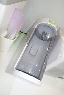 a toothbrush and toothpaste dispenser sitting on a counter