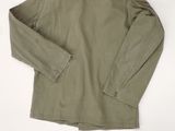 the back view of a khaki jacket with a white background