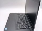 a laptop computer sitting on a table with a keyboard
