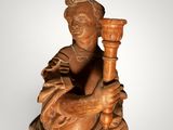an image of a wooden statue of a man holding a torch