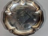a silver plate with a flower design on it