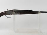 a rifle on a clear stand with a white background