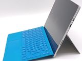 a laptop with a blue keyboard sitting on top of it