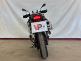 a motorcycle parked in a garage with a sign on the back of it