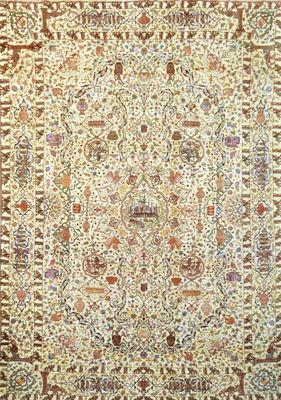 a beige and brown rug with an ornate design on it