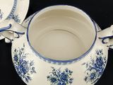 a blue and white cup and saucer on a black table