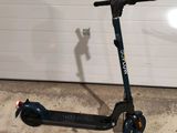 a scooter that is parked in front of a garage