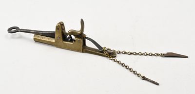 a small metal tool with a chain attached to it