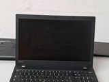 a laptop that is sitting on a desk next to a keyboard