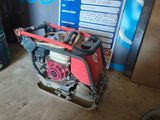 une petite machine rouge et noire garée dans un garage