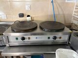 a stove with a pan on top of it in a kitchen