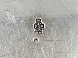 a close up of a silver plate with a small piece of writing on it