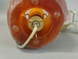a close up of an orange object on a white surface