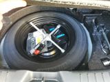 a close up of a tire in the trunk of a car